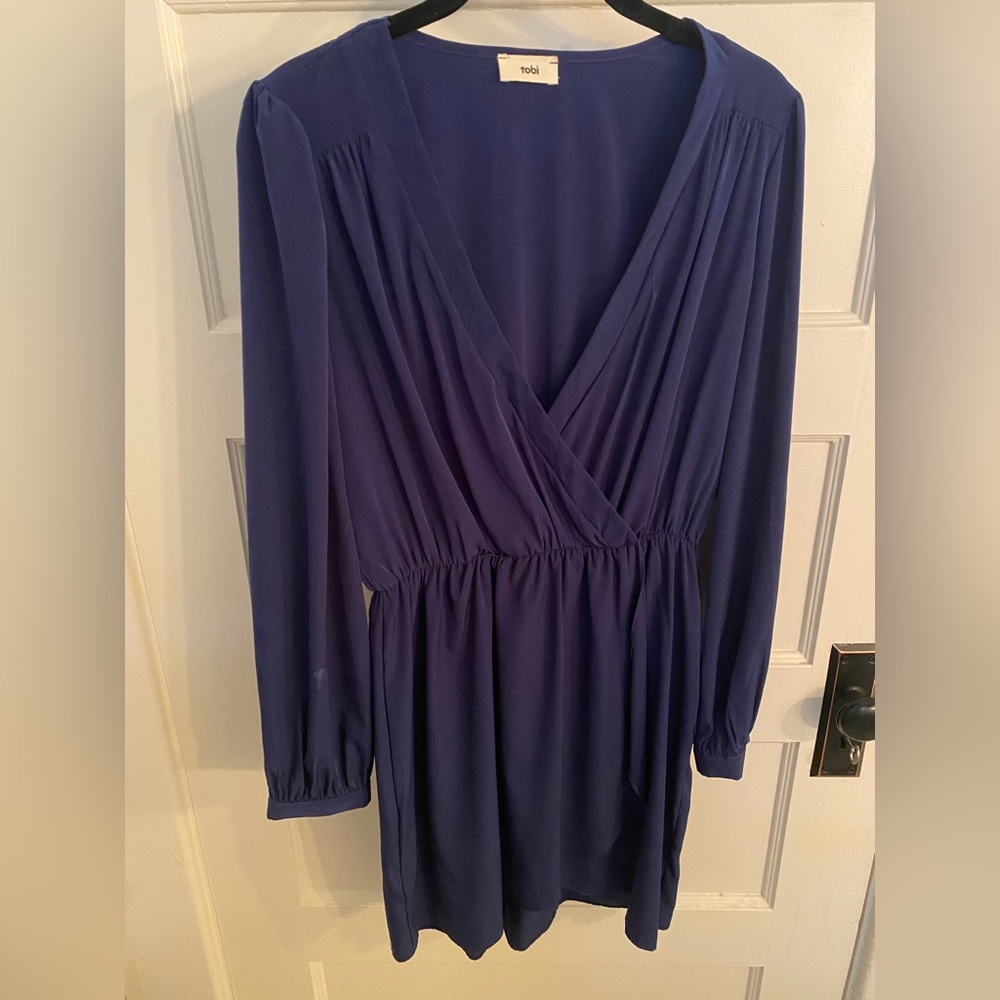 Dark blue long sleeved dress with plunge neckline and cinched waist